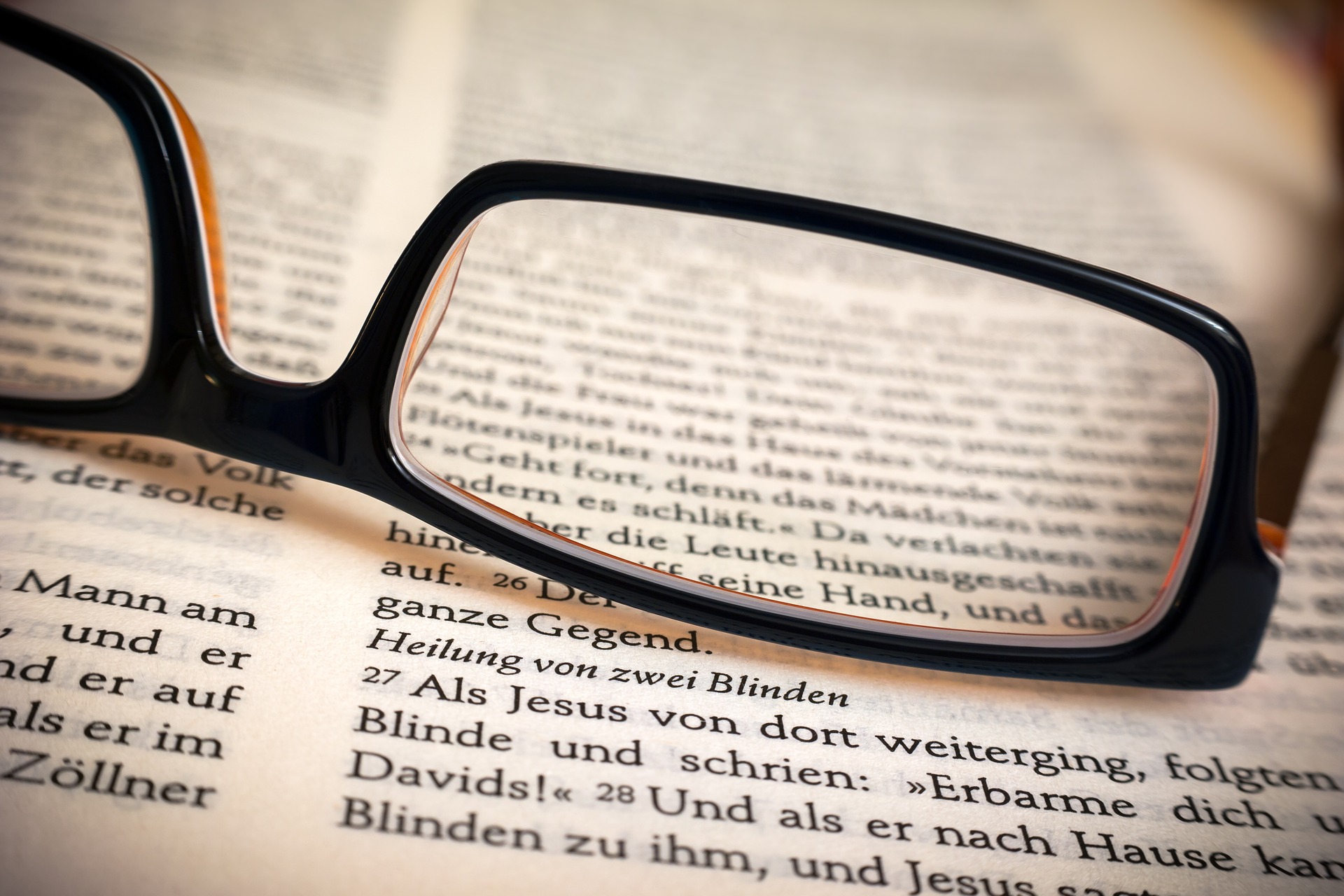 A pair of glasses laying on a table.